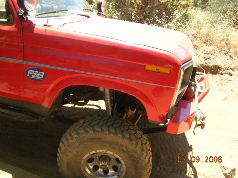 1985 Ford Bronco - This red SUV is equipped for off-road use, large tires and a modified bumper.