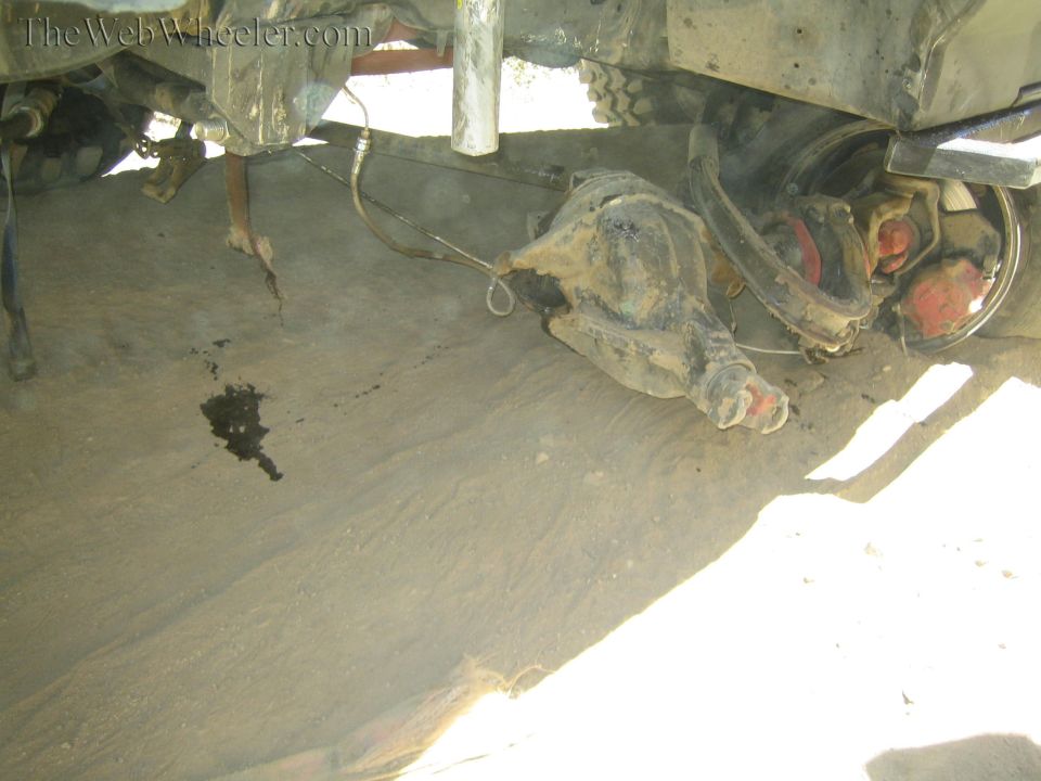 Underside of a truck showing a detached or dropped front axle housing