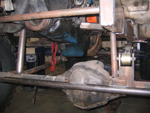 1982 Ford Bronco - Close-up of the vehicle's undercarriage, showing the engine oil pan and rear differential assembly.