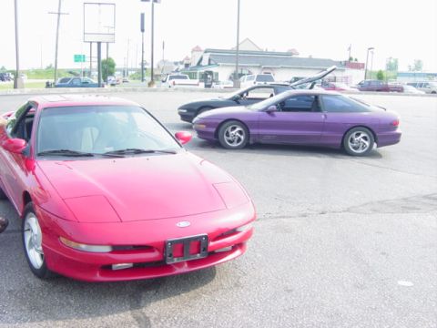 1995 Ford Probe - A red 1995 Ford Probe is parked in a lot with two other coupes.