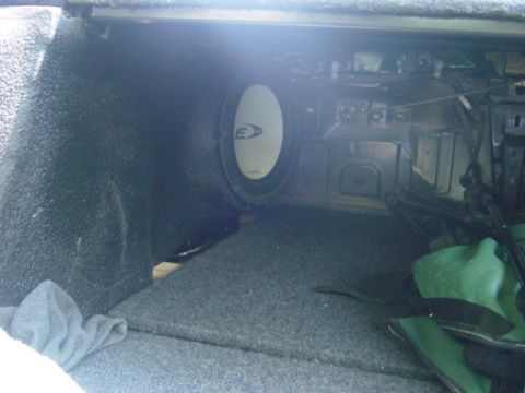 1995 Ford Probe - Interior view of a car trunk showing a subwoofer and a green bag.