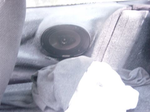 1995 Ford Probe - A rear speaker is visible in the interior of a car, partially obscured by fabric.