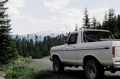 1979 Ford Bronco - A white 1978 Ford Bronco sits on a dirt road with a mountain in the background.