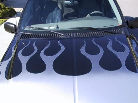 2001 Ford Excursion - Vehicle hood with flame decals, part of windshield and interior visible.