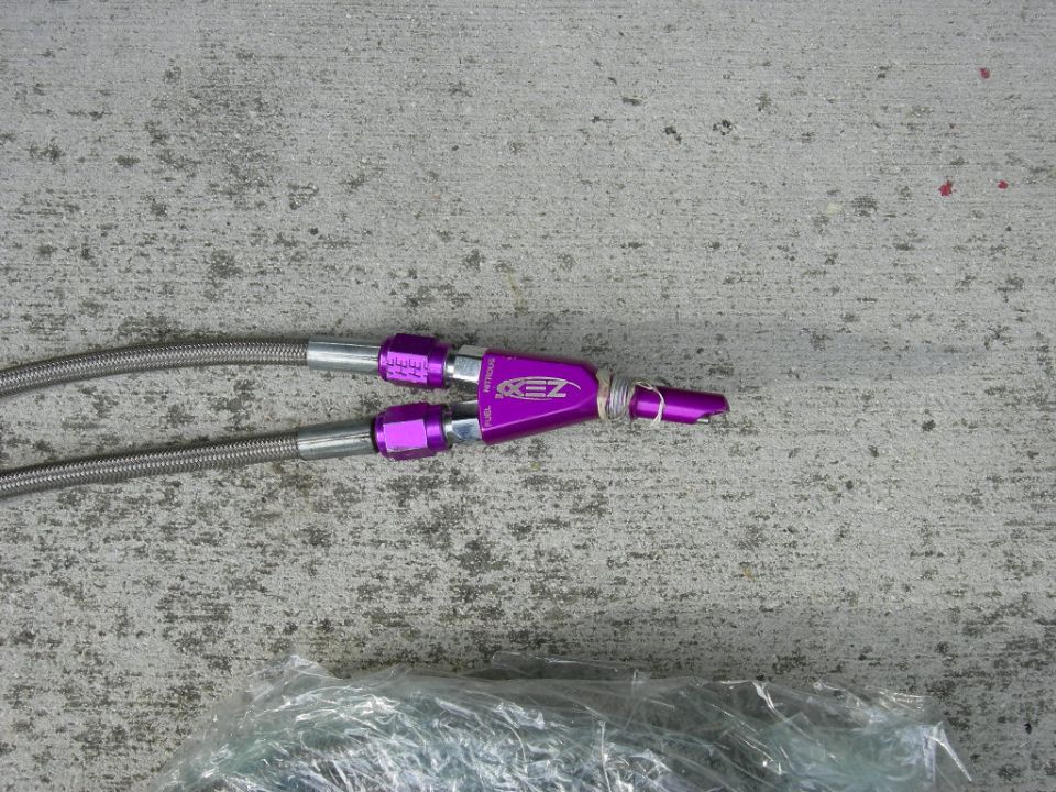 Purple anodized fuel line fittings with braided lines attached