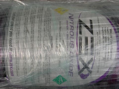 1996 Ford Probe - A Nitrous Oxide tank is shown, wrapped in plastic, with various warnings and specifications printed on it.