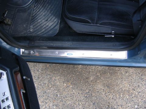 1988 Ford Crown Victoria LTD - Close-up of a Ford door sill plate, showing the emblem and interior carpet.
