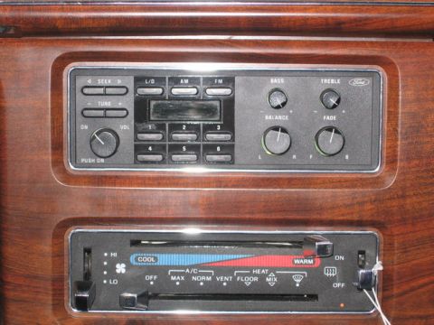 1988 Ford Crown Victoria LTD - Dashboard interior with radio and climate controls, wood grain trim visible.