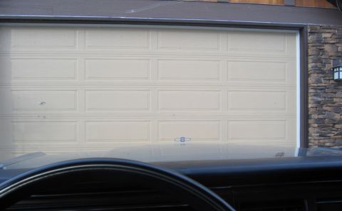 1988 Ford Crown Victoria LTD - View from inside a vehicle looking towards a closed garage door.