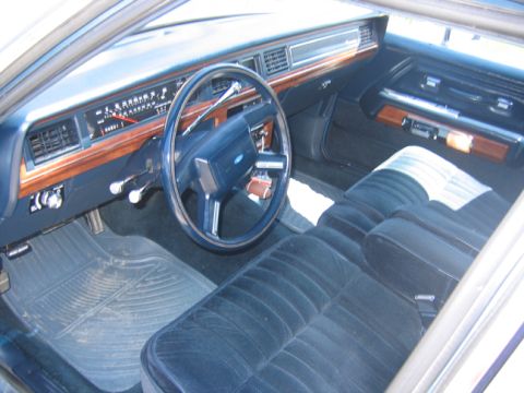 1988 Ford Crown Victoria LTD - Interior view of a 1988 Ford Crown Victoria LTD, highlighting the dashboard and seating.