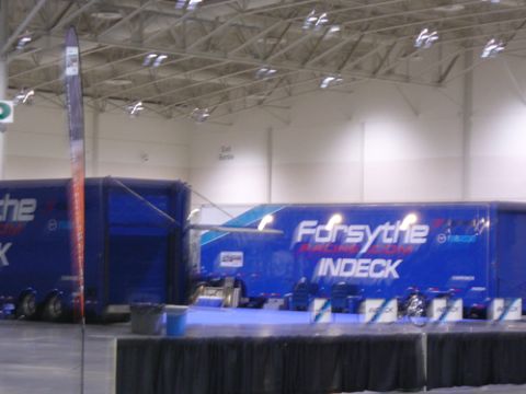 1995 Ford Taurus - Two blue racing trailers with 'Forsythe' and 'INDECK' logos are parked indoors.
