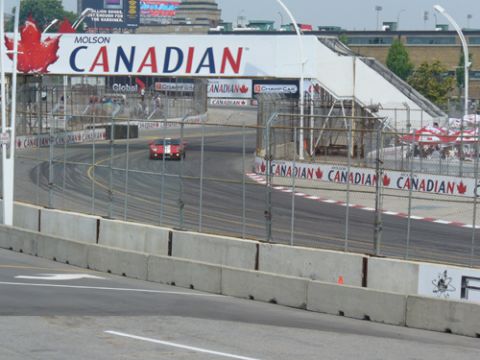 1995 Ford Taurus - A race car navigates a track under a large Molson Canadian banner.