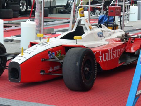 1995 Ford Taurus - Open-wheel race car with "Gulfstream" branding on the side, parked on a red surface.