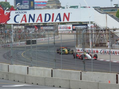 1995 Ford Taurus - Race cars compete on a track under a large Molson Canadian banner.