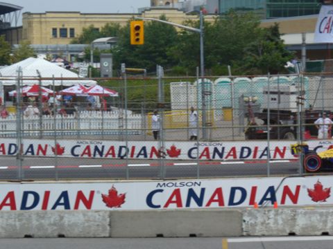 1995 Ford Taurus - A race car is visible on a track with Molson Canadian banners lining the barrier.
