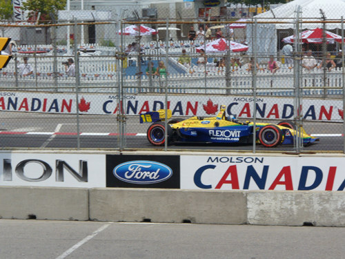 Yellow and blue race car with number 16 on track