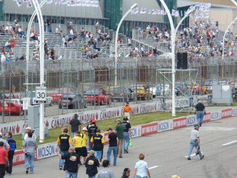 1995 Ford Taurus - A race track event with spectators in the stands and cars visible on the track.