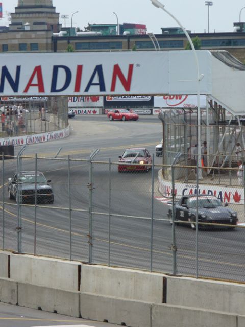 1995 Ford Taurus - Cars compete on a race track with a large banner overhead.