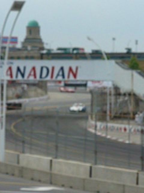 1995 Ford Taurus - Cars race on a track under a banner that reads "CANADIAN".