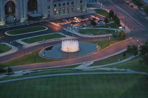 1998 Jeep TJ - A wide view of a parking lot and a fountain in front of a large building.