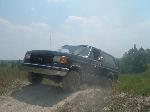 1988 Ford Bronco - This Ford Bronco is tackling an off-road trail on a sunny day.