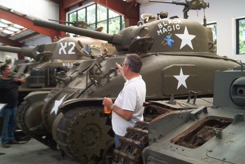 1966 Jeep CJ5 - Museum display features multiple tanks, including one with "BLACK MAGIC" painted on its turret and a "X2" marking.