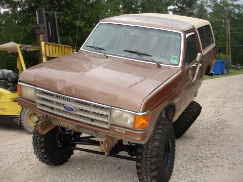 1987 Ford Bronco - This lifted 1987 Ford Bronco features oversized tires and a modified suspension system, giving it an aggressive stance.