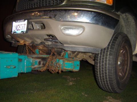 1992 Ford Bronco - Front view of a truck with a tow hitch attached, showing the bumper and tire.
