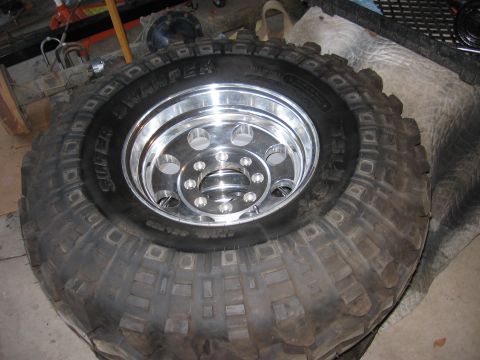1990 Ford Bronco - A Super Swamper tire is mounted on a shiny chrome wheel, likely for an off-road vehicle.
