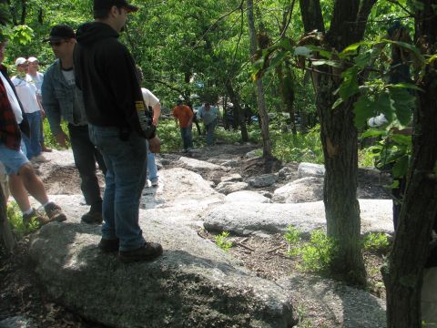1992 Ford Bronco - People gather on a rough, rocky trail surrounded by trees.