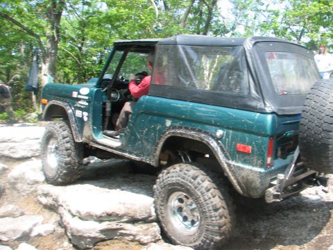 1992 Ford Bronco - This vintage SUV navigates a rocky trail, its off-road capabilities.