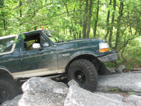 1992 Ford Bronco - This 1992 Ford Bronco is shown tackling a challenging rocky terrain on an off-road path.
