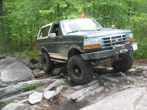 1992 Ford Bronco - This 1992 Ford Bronco is shown tackling a challenging off-road course with large rocks.