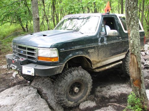 1992 Ford Bronco - This modified 1992 Ford Bronco tackles a challenging rocky trail, its off-road capabilities.