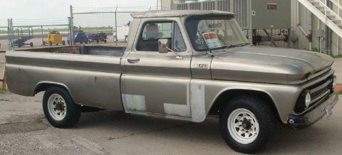 1986 Ford Bronco - This Chevrolet C10 pickup truck has a patched body and white rims.