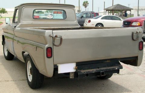 1986 Ford Bronco - This vintage pickup truck is parked outdoors with other vehicles visible in the background.