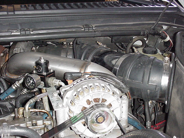 Engine bay showing alternator, intake tube, and fuel pressure regulator
