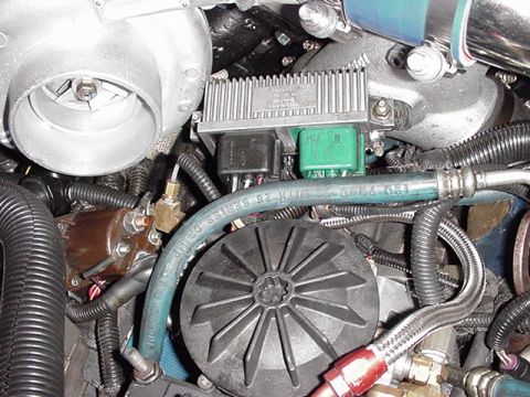 2000 Ford Excursion - Close-up view of various engine parts, including a turbocharger and fuel filter assembly.