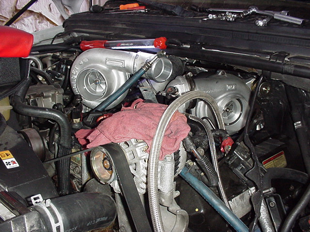 Engine bay with twin turbochargers and a red shop rag