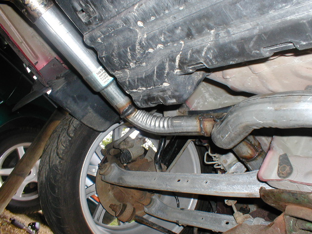 Undercarriage view of exhaust system and rear suspension components