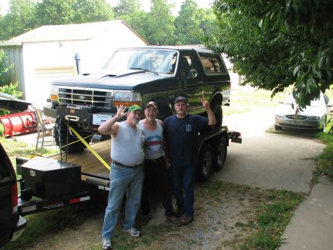 1992 Ford Bronco - Three men pose with a dark green 1992 Ford Bronco loaded onto a trailer.