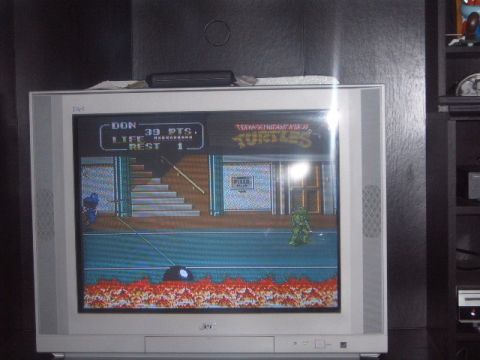 1988 Ford Bronco - A television displays the Teenage Mutant Ninja Turtles video game, score and life status for the player.