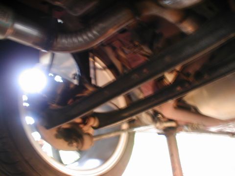 1998 Ford Taurus - Undercarriage view showing exhaust and wheel, with Supermotors.net logo.