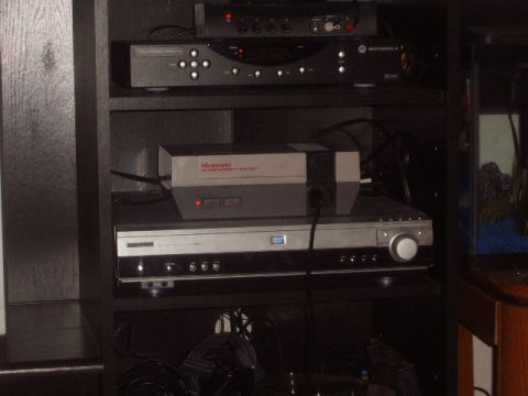 1988 Ford Bronco - Various electronic devices are organized on shelves, with a Nintendo console prominently displayed.