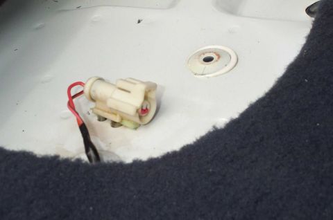 2001 Ford Crown Victoria - A close-up view of an electrical connector with a red wire, likely part of a vehicle's wiring harness.