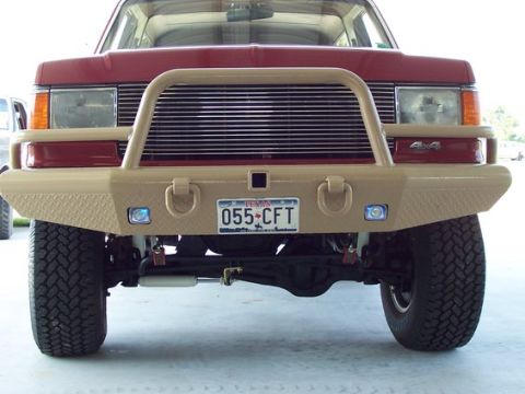 1996 Ford Bronco - Front view of a red Ford Bronco with a custom tan bumper and bull bar, displaying a Texas license plate.