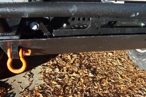 1996 Ford Bronco - Close-up view of a black bumper with an orange tow hook and a portion of a tire visible.