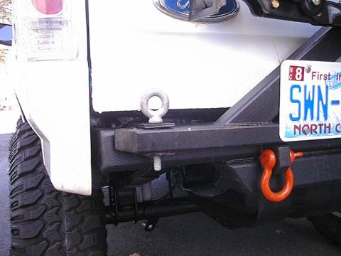 1996 Ford Bronco - The rear of a vehicle is shown, a heavy-duty bumper with recovery points and a license plate.