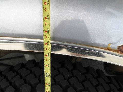 1995 Ford Bronco - A tape measure is used to show the height of a silver SUV's fender, indicating approximately 40 inches.