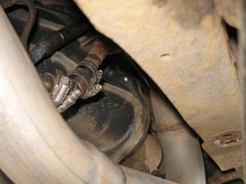 1995 Ford Bronco - Detail of an exhaust pipe connection with a hose clamp.